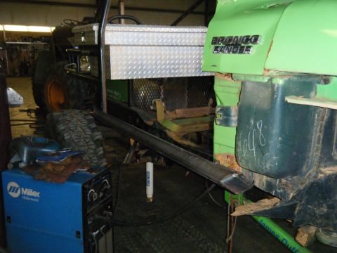 1978 Ford Bronco - A green 1978 Ford Bronco Ranger is seen in a workshop with a toolbox and welding equipment nearby.