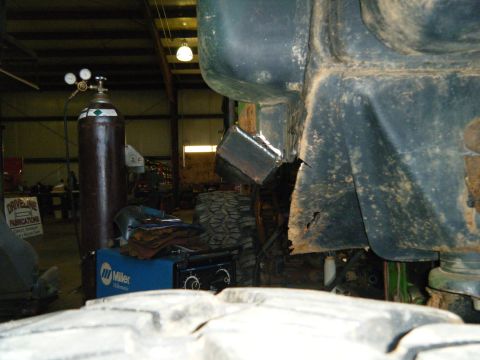 1978 Ford Bronco - A welding project is underway on the frame of a vehicle, with a gas cylinder and welder nearby.