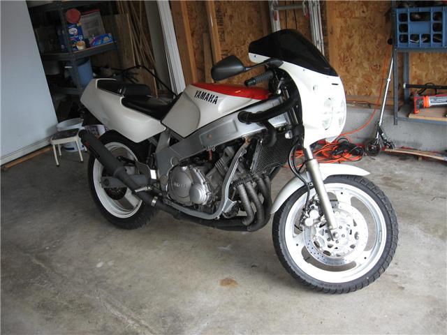 White and red Yamaha sport motorcycle parked in a garage