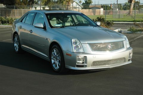 2006 Cadillac STS - A silver Cadillac STS is parked in a lot, showing its distinctive grille and headlights.