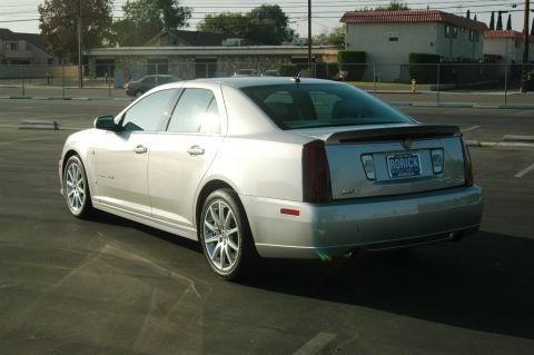 2006 Cadillac STS - The rear of a silver 2006 Cadillac STS is shown parked in an outdoor lot.