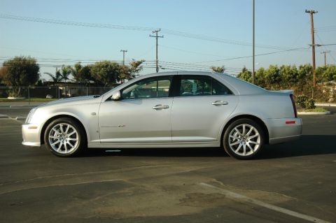 2006 Cadillac STS - A silver 2006 Cadillac STS sedan is shown from its side in a parking lot under a clear sky.