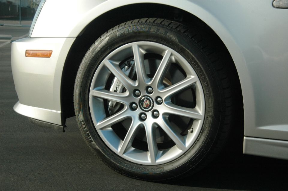 Silver Cadillac front alloy wheel with Cadillac crest cap and Pirelli tire