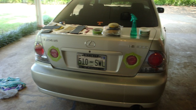 Rear of a silver Lexus IS sedan with detailing supplies on trunk