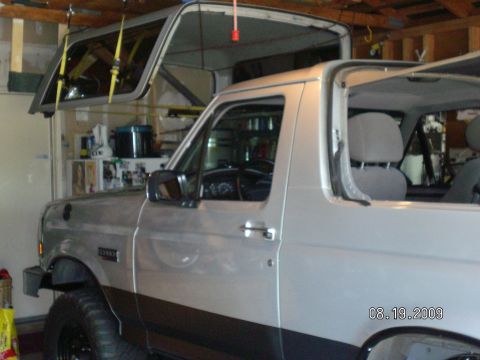1996 Ford Bronco - 1996 Ford Bronco's removable hardtop is stored overhead in a garage.