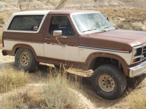 1985 Ford Bronco - This two-tone brown and white Ford Bronco appears to be from the early 1980s, with its distinctive body style.