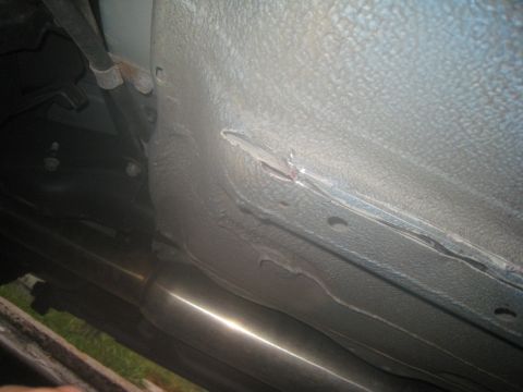 2007 Subaru Impreza - Damage is visible on the frame of the vehicle, with a portion of the exhaust system also in view.