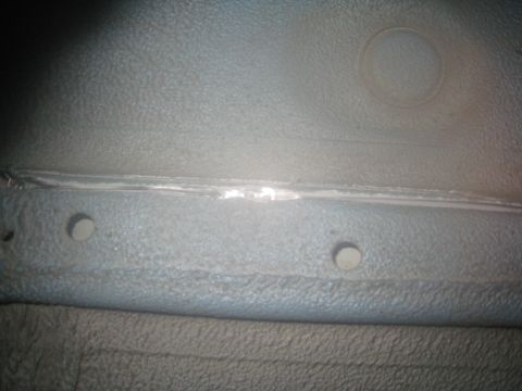 2007 Subaru Impreza - Detail of a vehicle's interior, showing a seam and two circular indentations, possibly in the trunk or undercarriage area.