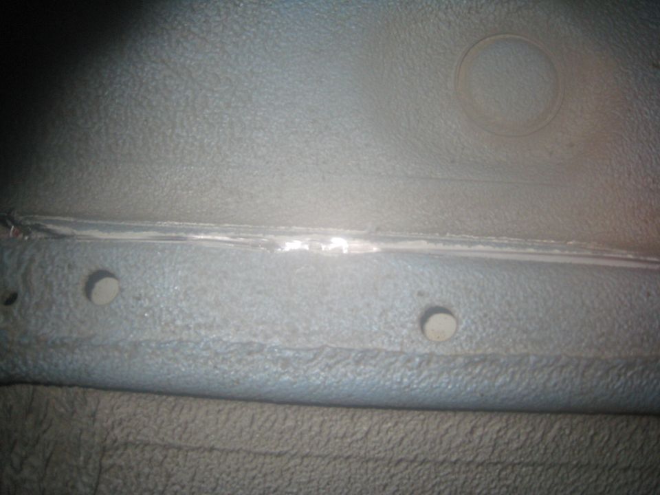 Close-up of vehicle interior seam with two circular holes