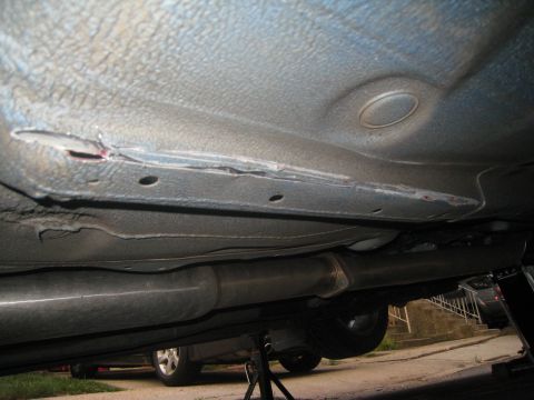 2007 Subaru Impreza - Damage to the car's underbody, including the frame and exhaust components.