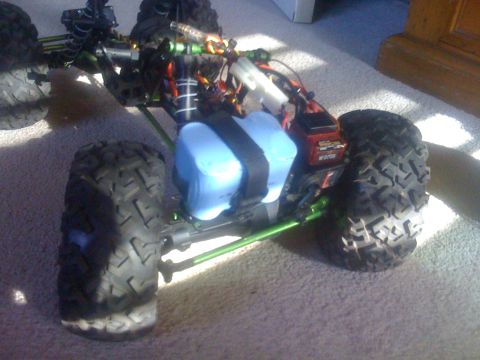 1995 Ford Bronco - This remote control car features a blue battery pack and prominent green suspension parts.