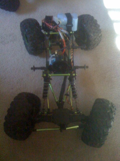 1995 Ford Bronco - Chassis of a remote control rock crawler with visible suspension and wiring.