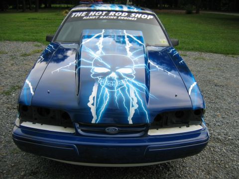 1992 Ford Mustang - Custom painted 1992 Ford Mustang front end features a skull and lightning bolt graphic. "THE HOT ROD SHOP" sticker is visible.
