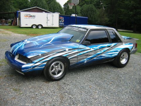1992 Ford Mustang - This customized 1992 Ford Mustang features a striking lightning bolt paint scheme and performance modifications.