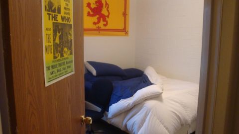 1996 Ford Bronco - A bedroom scene with a bed, a poster for The Who, and a Scottish flag on the wall.