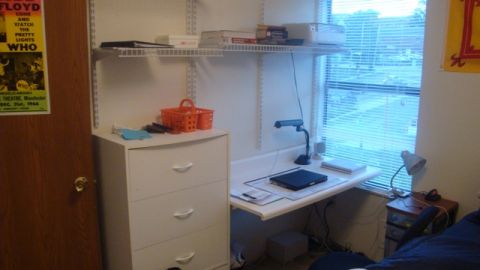 1996 Ford Bronco - Desk setup in a dorm room, a laptop and a Pink Floyd poster on the door.