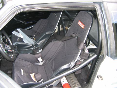 1992 Ford Mustang - The interior of the car features racing seats and a roll cage, suggesting it's set up for performance driving.