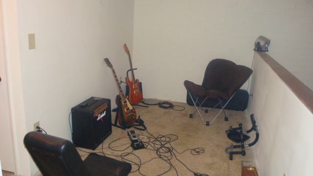 Loft music corner with electric guitars, a Marshall amp and pedalboard on carpet