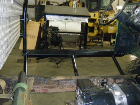 1978 Ford Bronco - The chassis and engine of a 1978 Ford Bronco are visible, along with part of the steering wheel and dashboard.
