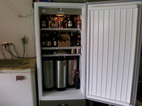 1985 Ford LTD Crown Victoria - A home refrigerator is stocked with various beverages and three beer kegs.