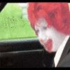 1996 Ford Bronco - A clown with a painted face peers into the interior of a vehicle.