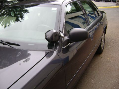2001 Ford Crown Victoria - This 2001 Ford Crown Victoria is seen from a 3q-front angle, a spotlight mounted on the windshield.