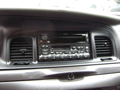 2001 Ford Crown Victoria - Close-up of a car's interior dashboard, focusing on the radio and air conditioning vents.