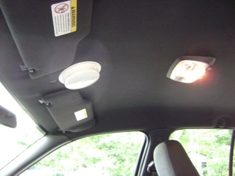 2001 Ford Crown Victoria - Interior view of a car's ceiling, showing sun visors and interior lights.