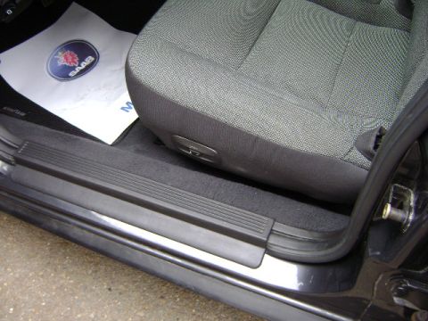 2001 Ford Crown Victoria - Interior shot of a car, a Saab floor mat and the driver's seat.