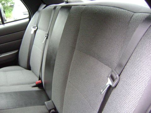 2001 Ford Crown Victoria - Interior view of the back seat, showing fabric upholstery and seat belts.