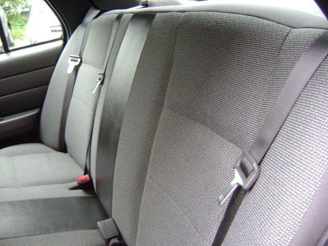 Rear seat interior with grey fabric and black seat belts