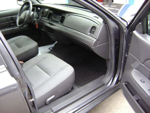 2001 Ford Crown Victoria - Interior view of a dark gray vehicle, focusing on the front seats and dashboard area.