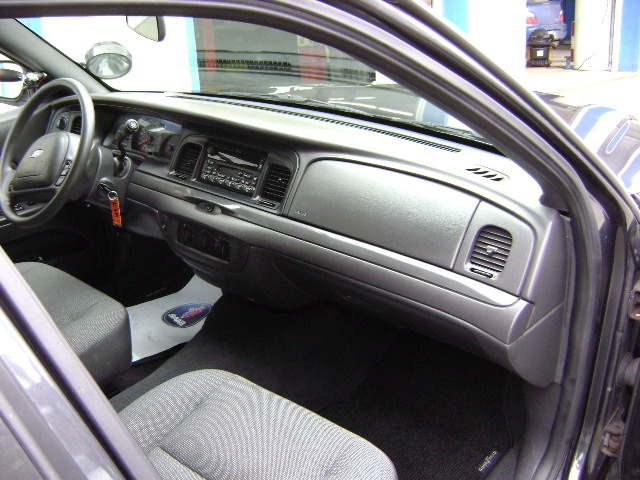 Interior of a 2001 Ford Crown Victoria, showing the dashboard, steering wheel, and front seats