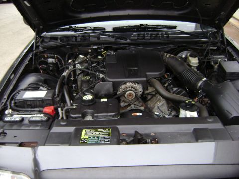 2001 Ford Crown Victoria - The engine bay of a Ford Crown Victoria is pictured, revealing the V8 engine and associated components.