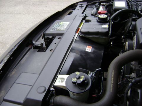 2001 Ford Crown Victoria - A close-up view of a vehicle's engine bay, showing various components and hoses.