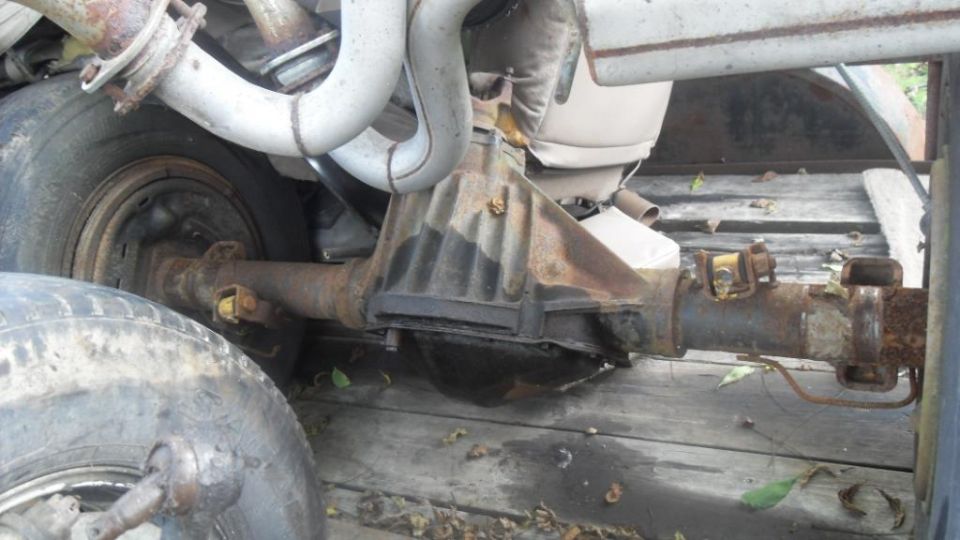 close-up of rusty rear axle and exhaust pipes