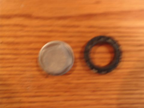 1996 Ford Bronco - A fuel pump and a rubber seal are shown on a wooden background.