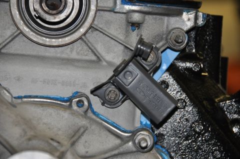 1996 Ford Bronco - Close-up of an engine component, likely a sensor, with visible part numbers.