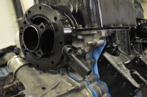 1996 Ford Bronco - Close-up view of a crankshaft pulley and sensor assembly attached to an engine block.