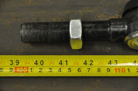 1996 Ford Bronco - A close-up shows a tie rod end with a measuring tape indicating approximately 40-43 cm.