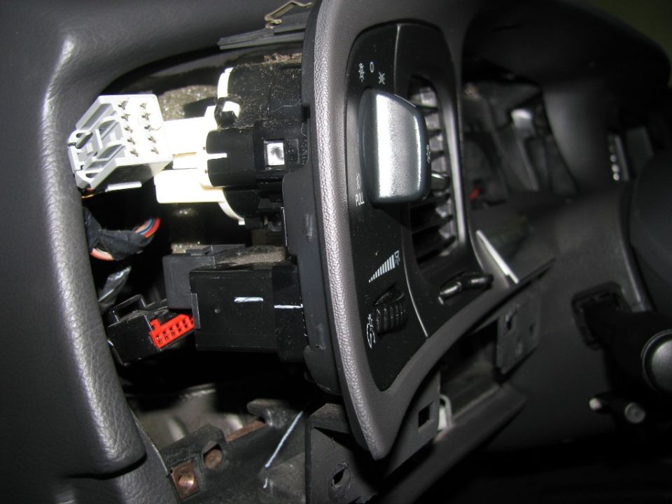 Disconnecting the headlamp and dimmer harnesses. Be sure to disconnect the battery or the headlamps with illuminate.