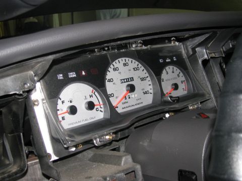2003 Mercury Marauder - The gauge cluster displays 'Marauder' and mileage, but no year is visible.