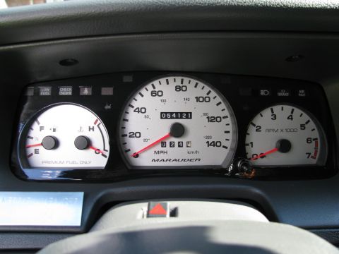 2003 Mercury Marauder - The custom gauge cluster trim panel for a Marauder features white-faced gauges with red needles and clear markings.