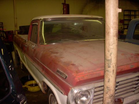 1993 Ford Bronco - This red and white pickup truck, possibly a Ford F-150, is shown in a garage setting. The registry label of 1993 Ford Bronco is incorrect.