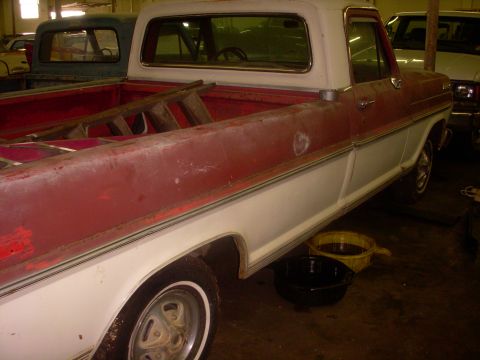 1993 Ford Bronco - This red and white Ford pickup truck appears to be from the late 1960s, not a 1993 Bronco.