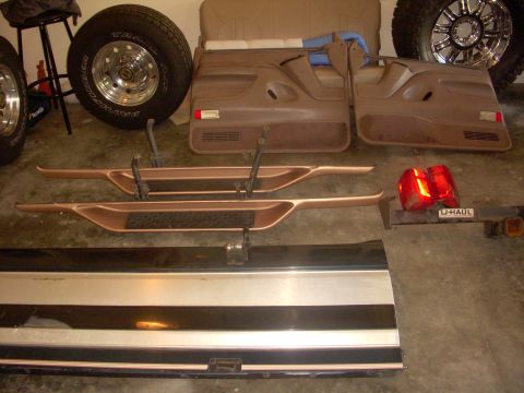 1993 Ford Bronco - Various automotive parts are displayed, including interior door panels and exterior trim pieces.