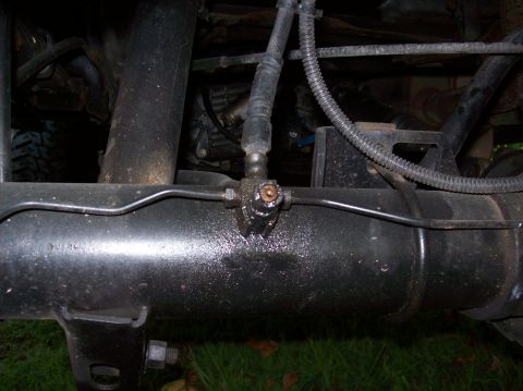 1992 Ford Bronco - Detail of a vehicle's rear axle, focusing on the brake line connection point.