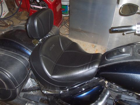 1994 Ford F-150 - Close-up of a motorcycle's black leather seat and saddlebags, with a portion of the handlebars visible.