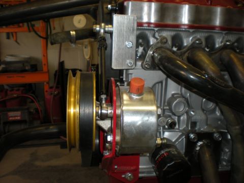 Suzuki Samurai - Close-up view of an engine's pulley system and power steering pump assembly.