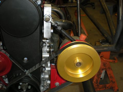 Suzuki Samurai - Close-up view of a gold pulley and black belt on an engine component, likely from a custom build.